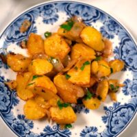 Closeup on a serving of oven-roasted potatoes and onions.