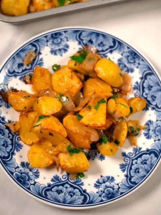 Closeup on a serving of oven-roasted potatoes and onions.