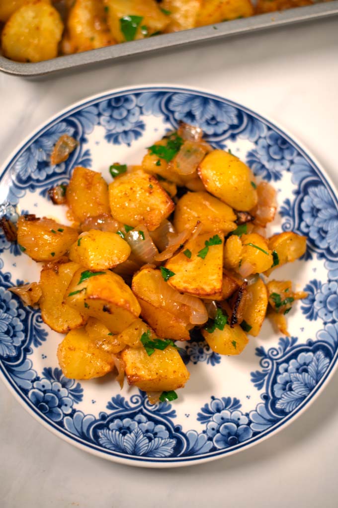 Closeup on a serving of oven-roasted potatoes and onions.