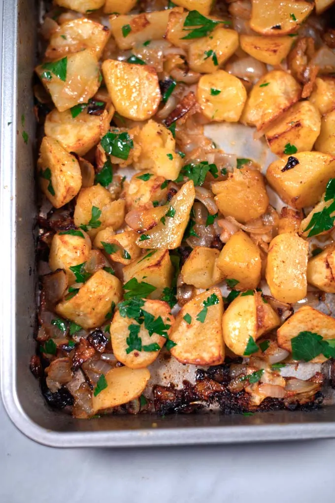 Closeup on oven-roasted potatoes and onions.