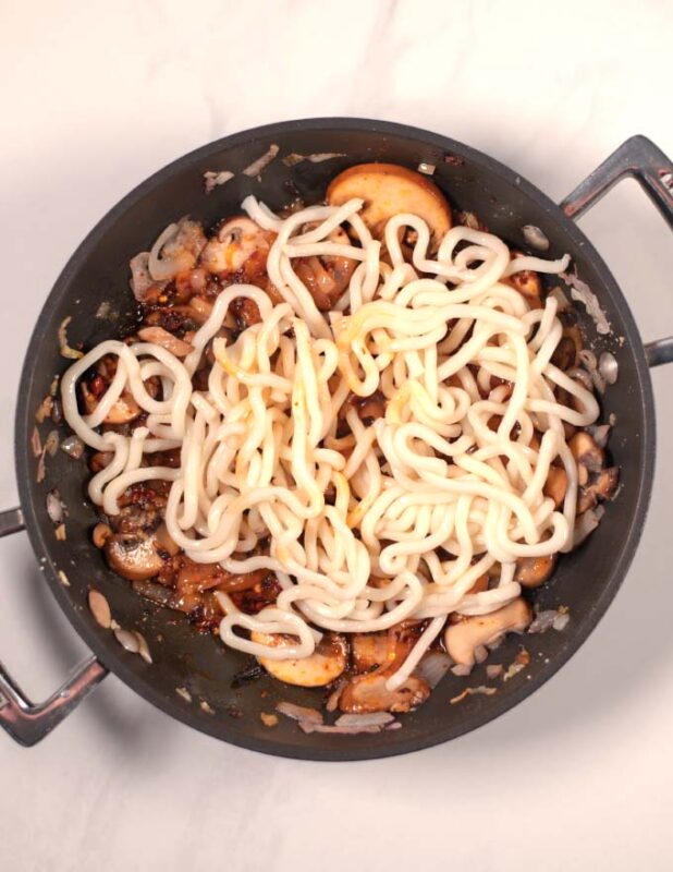 Precooked Udon Noodles are given to the pan.