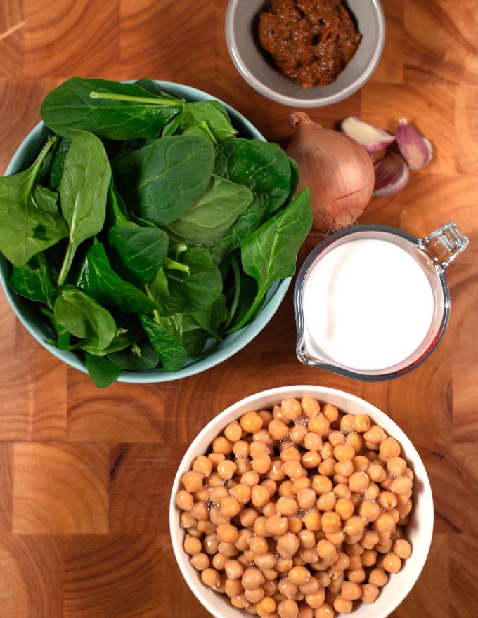 Ingredients needed to make Yellow Thai Curry on a board.