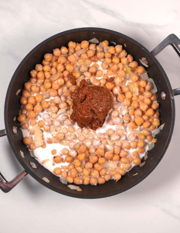 Chickpeas, coconut milk, and yellow Curry paste are mixed with onions.