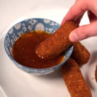 Dipping snacks into Bloves Sauce.